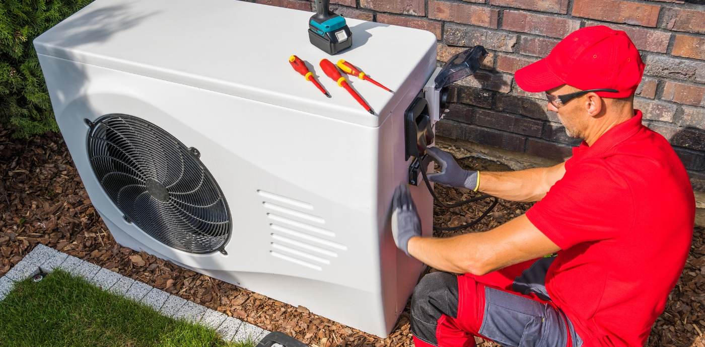 HVAC repair technician working on AC unit