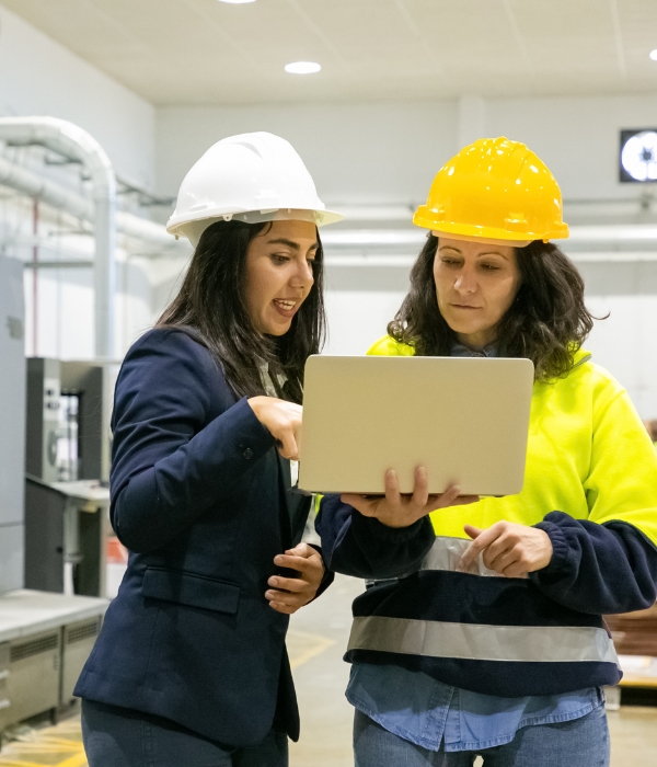 Manufacturing Digital Marketing Services (1) Manufacturer owner looking at laptop with employee