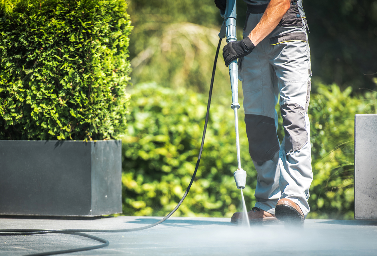 Patio Pressure Cleaning. Professional Washing Concrete Floor Patio Using High Pressured Water Cleaner.