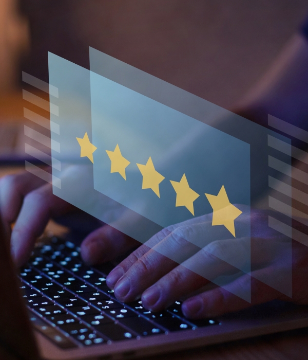 Person typing on keyboard with 5 stars overlay