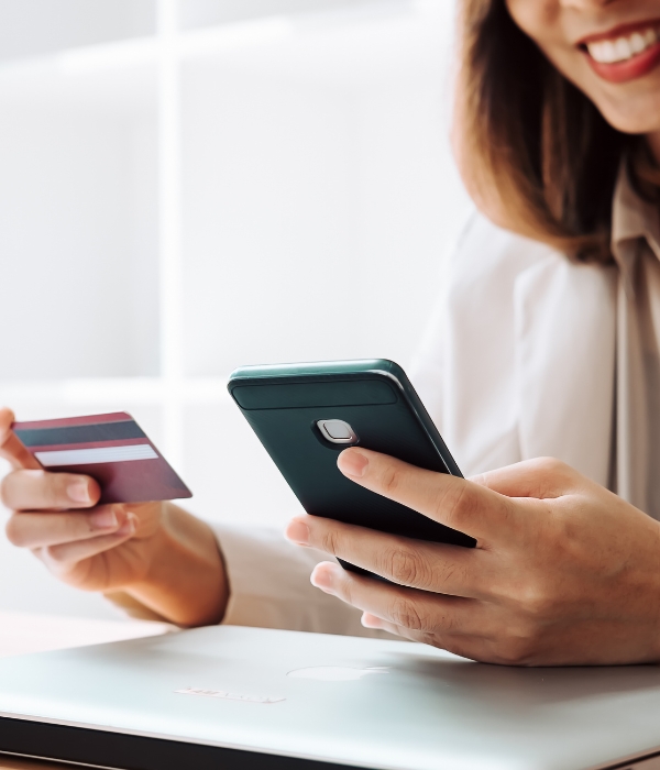 Woman holding mobile phone and credit card