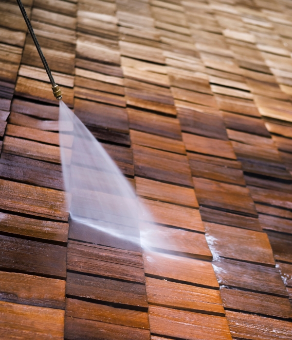 Shot of a pressure washer cleaning a shingle roof