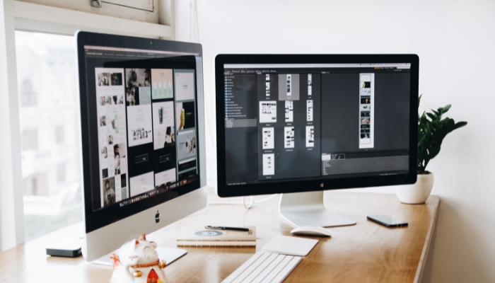 View of Website Development on two computer monitors