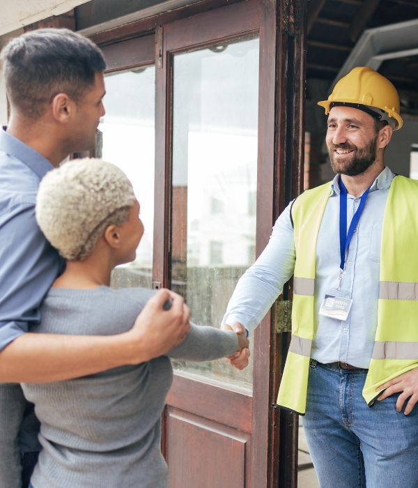 Home Builder shaking hands with couple