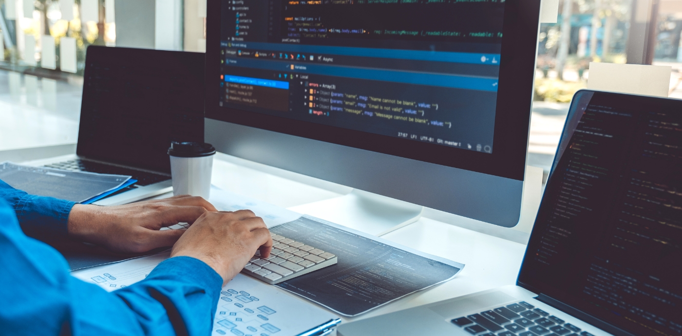 Person developing a website on a desktop computer